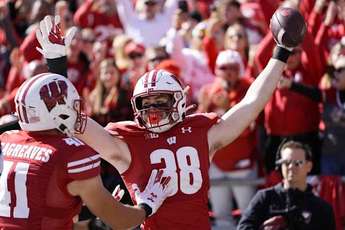 Oct 7, 2023; Madison, Wisconsin, USA; Wisconsin Badgers tight end Tucker Ashcraft (38) celebrates with wide receiver Skyler Bell (11) after scoring a touchdown during the fourth quarter against the Rutgers Scarlet Knights at Camp Randall Stadium. Mandatory Credit: Jeff Hanisch-USA TODAY Sports